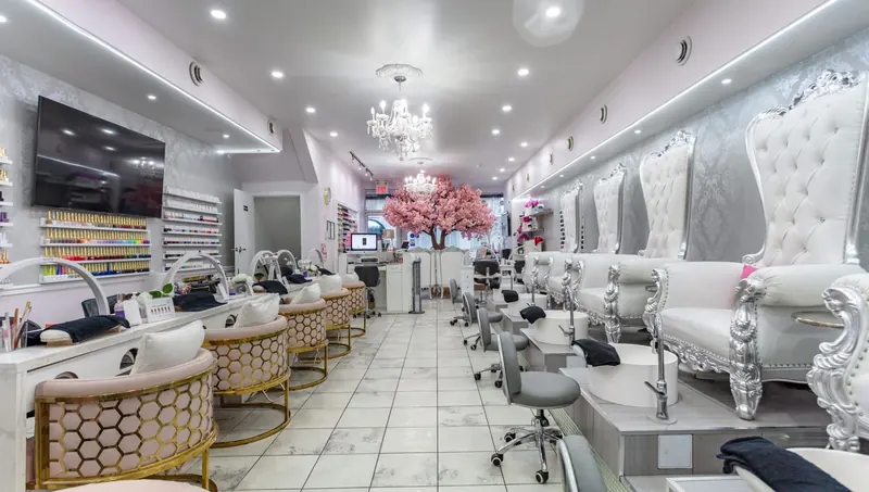 Inside Vanity Nail & Beauty Bar: plush seating beneath a cherry blossom tree