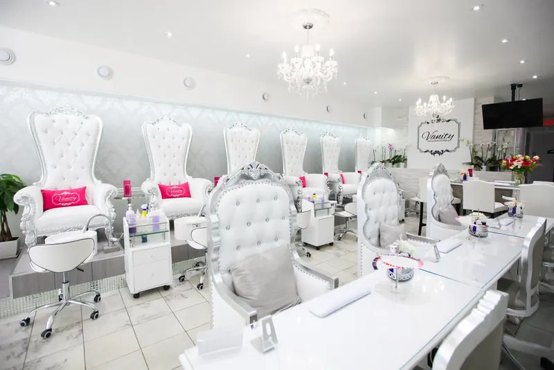 Manicure stations with white chairs