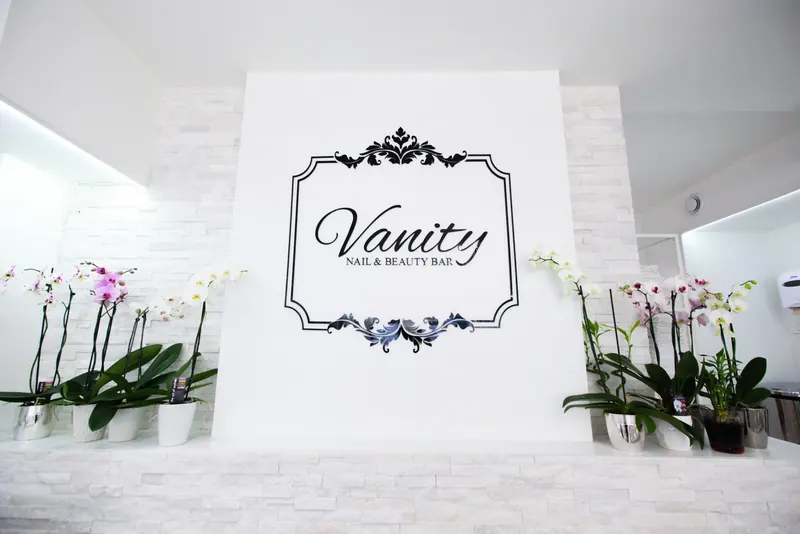 Vanity logo sign framed by white orchids